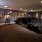 a room with a large group of chairs and a tv
