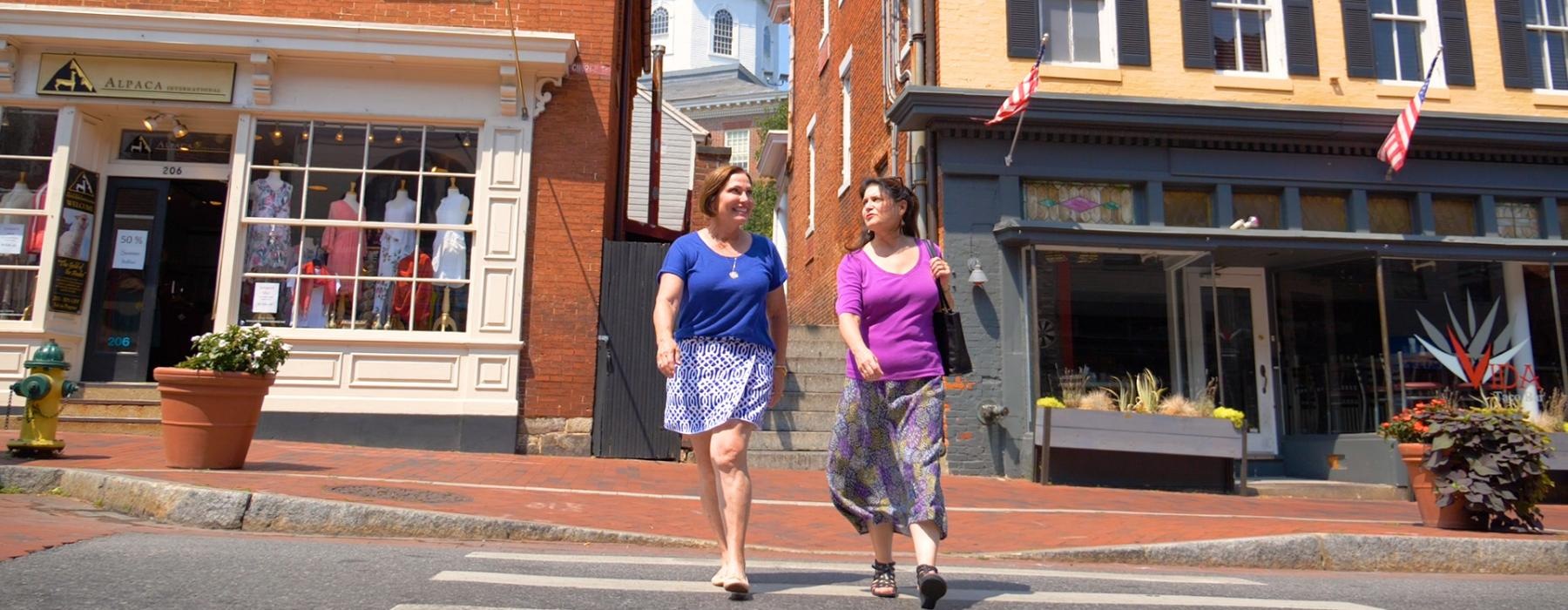 a couple of women walking down a street