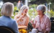 a few women laughing and drinking wine