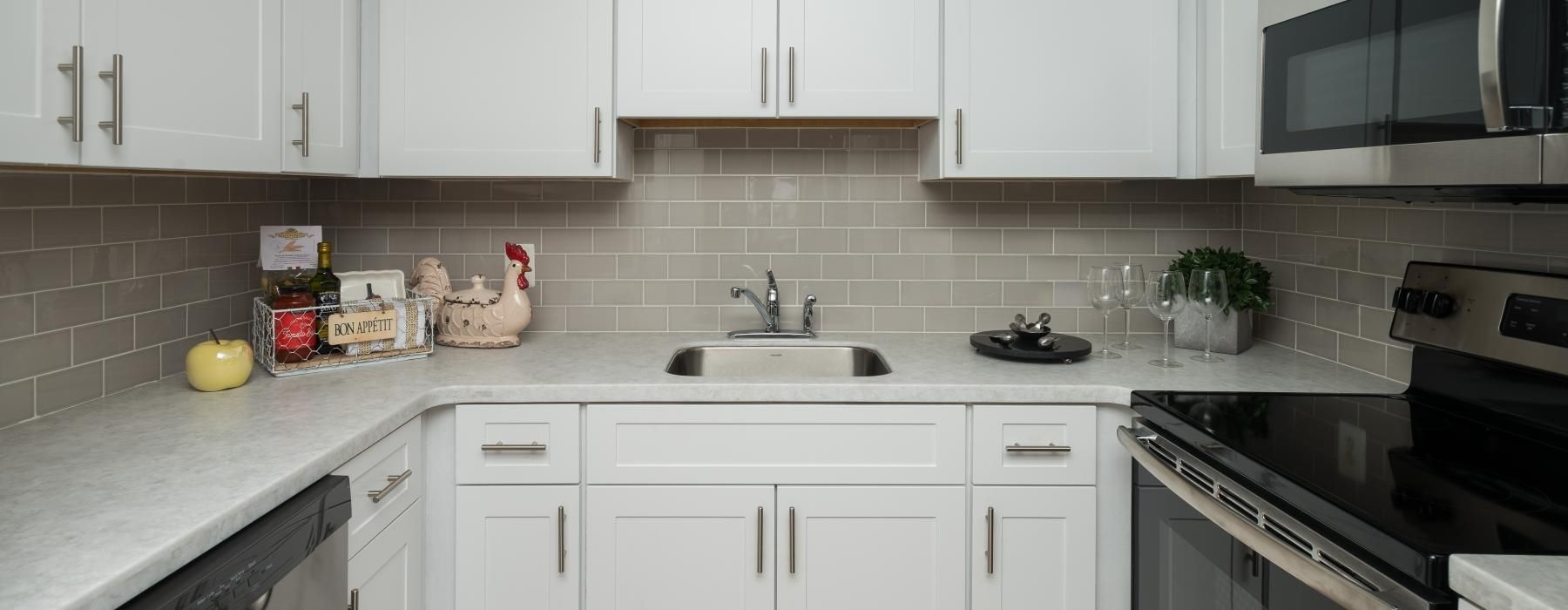 a kitchen with white cabinets